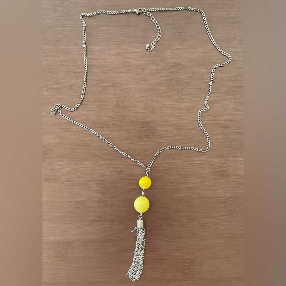 Long silver necklace with yellow beaded and tassel pendant